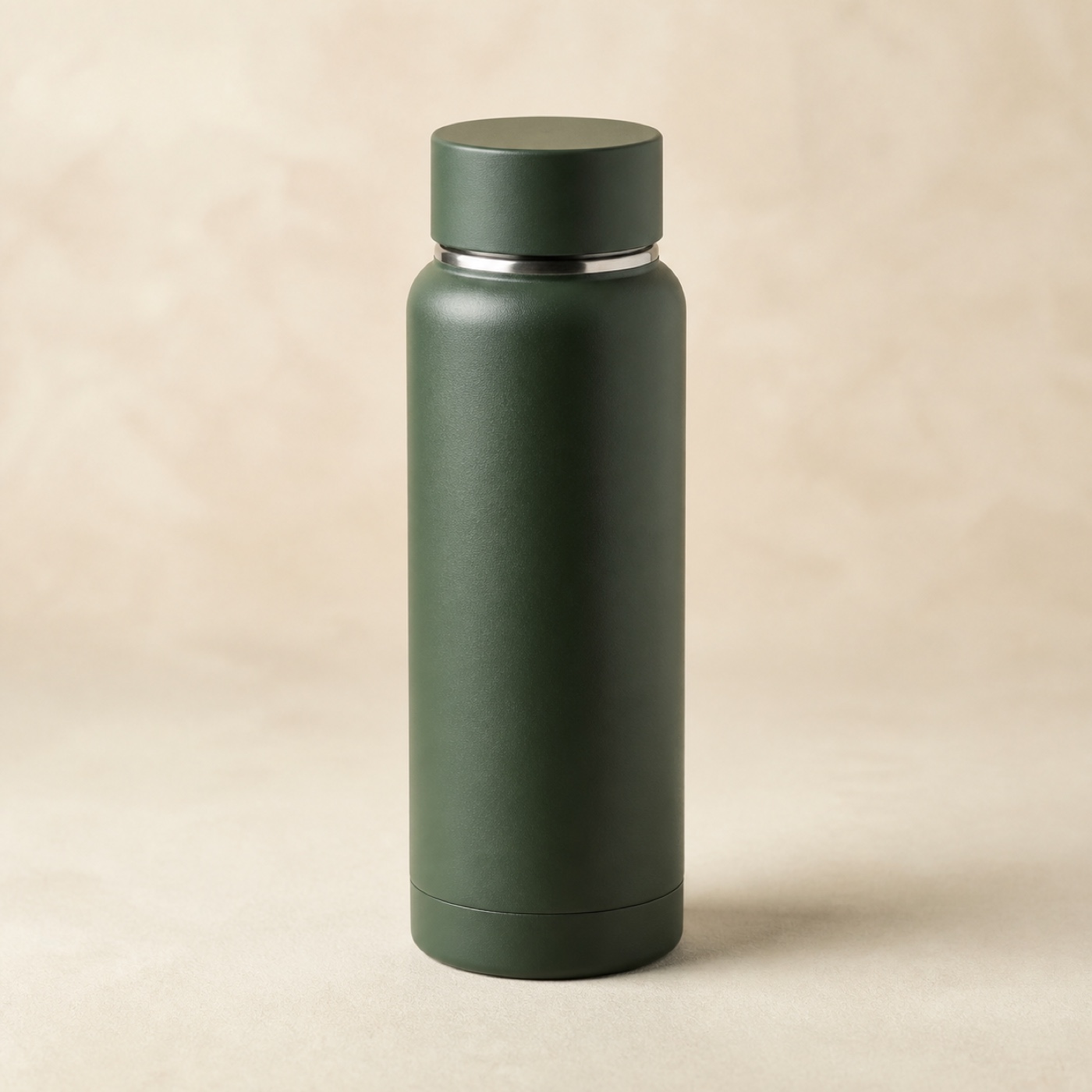 Matte forest-green Waypoint Bottle stainless vacuum travel bottle on a warm ivory surface